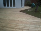 Decking linking pool and room after